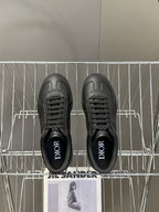 Black lace-up sneakers with Dior lettering on the inner lining