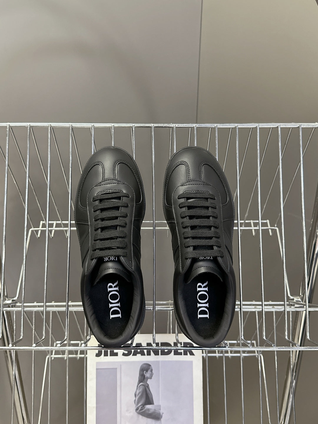 Black lace-up sneakers with Dior lettering on the inner lining
