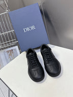 Black lace-up sneakers with smooth leather upper and rounded toe