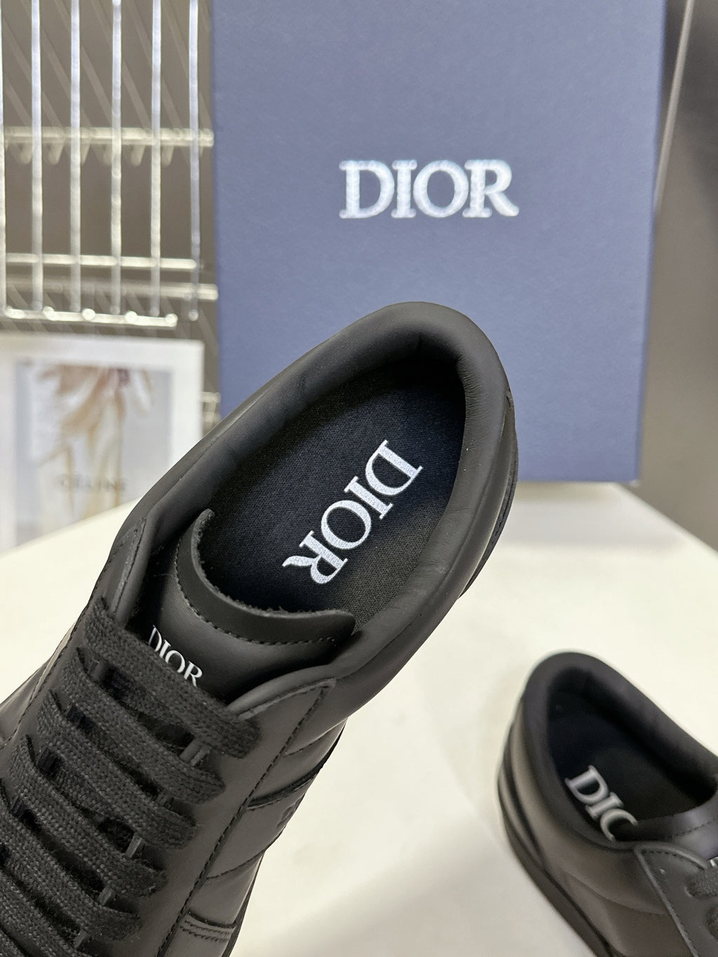 Black lace-up sneakers with Dior logo on tongue and cushioned collar