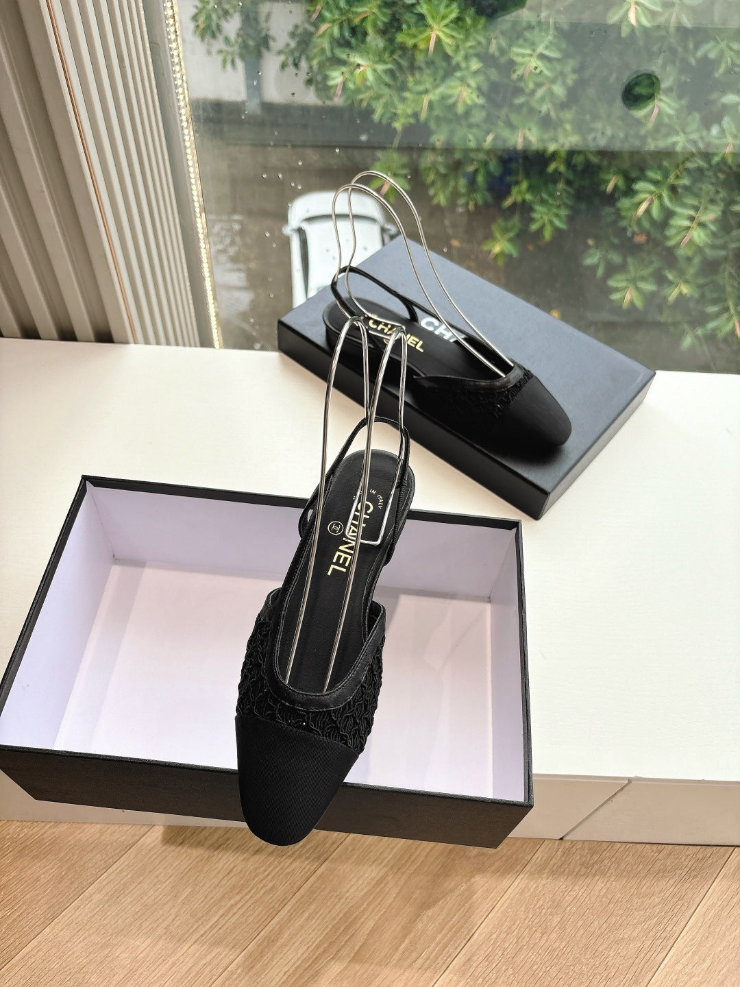 Black Chanel women's slingback shoes with logo ankle strap and slim pointed toe