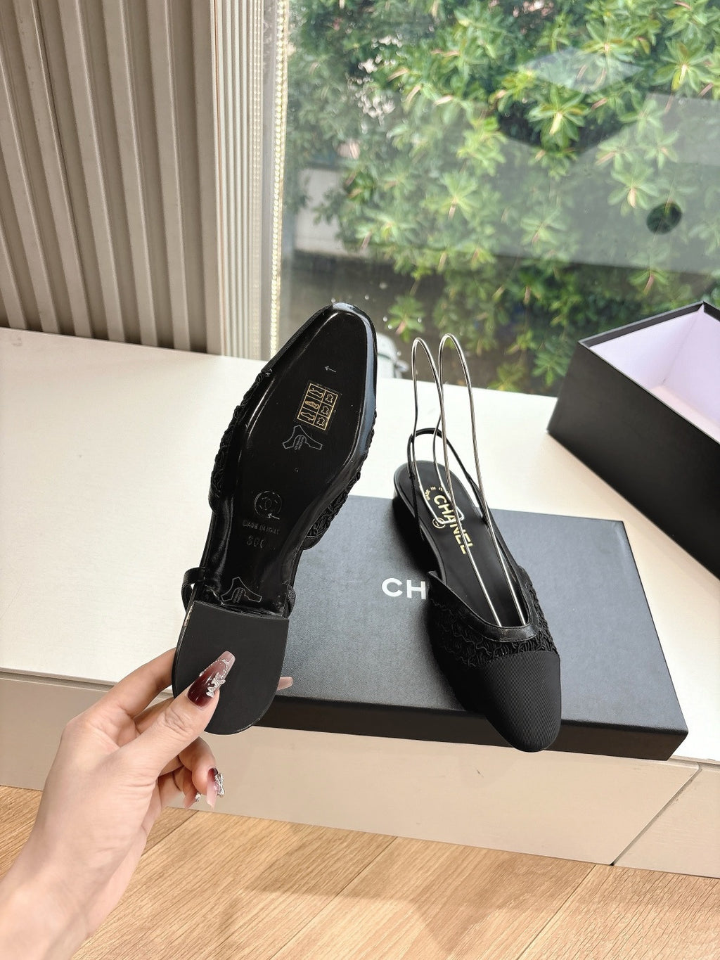 Black Chanel women's slingback shoes heel view, logo insole and pointed toe