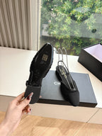Black Chanel women's slingback shoes heel view, logo insole and pointed toe