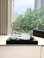 Chanel ladies slingback shoe on black display box, white textured upper with black heel