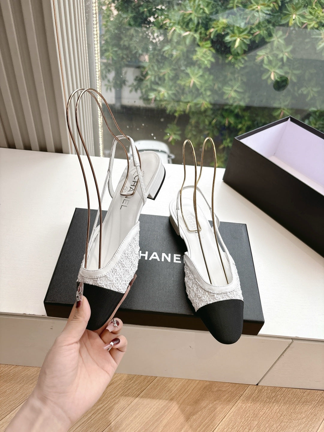 Chanel ladies slingback shoes, white textured upper with black heel and pointed toe, held