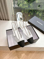 Chanel ladies slingback shoes, white textured upper with black heel, on display boxes