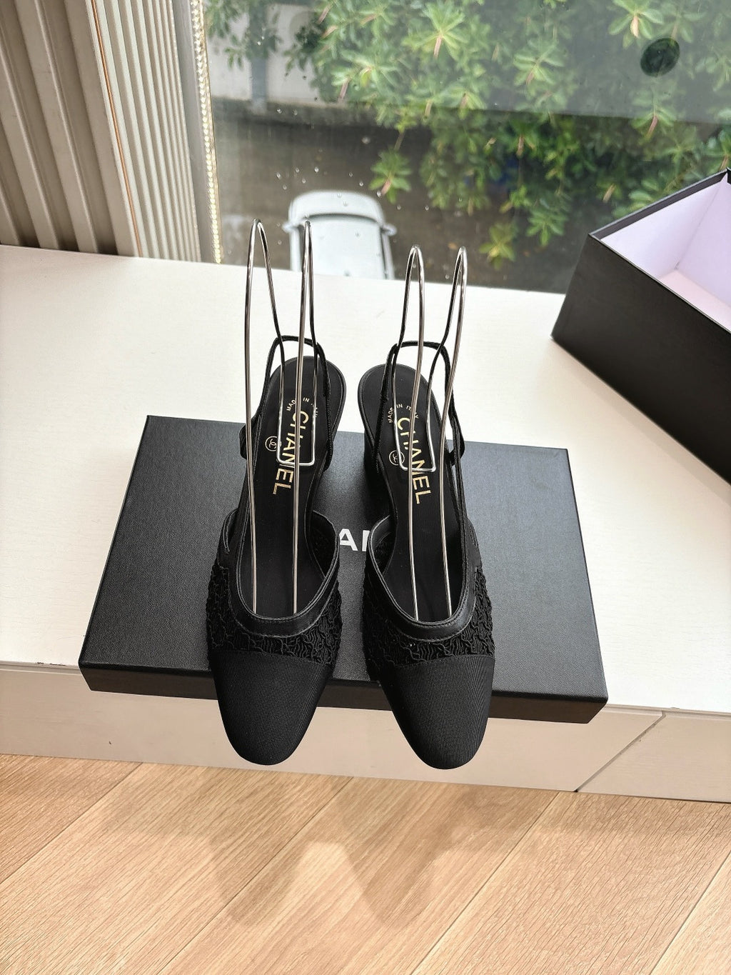 Black Chanel slingback shoes with pointed toe, slim heel, and logo insoles