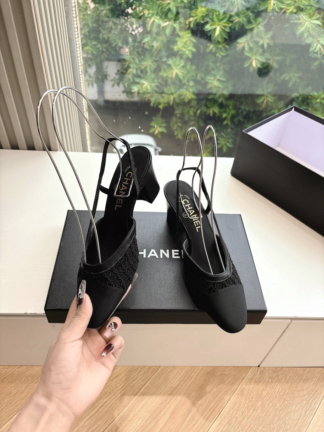 Black Chanel mule-style slingback shoes with textured front and slim heels