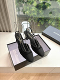 Black Chanel slingback heels with textured upper and low block heel