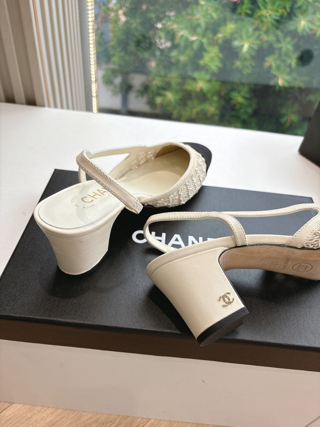 Two-tone women’s slingback heels with Chanel logo on strap and black toe caps
