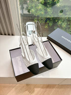 Two-tone women's slingback heels with textured white upper and dark toe panels