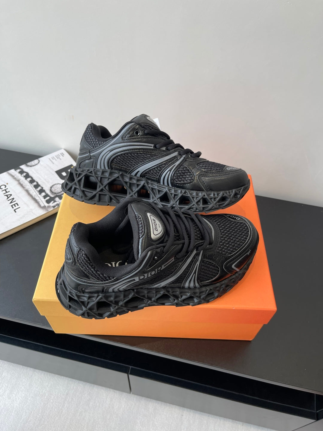 Dior ladies sneakers top view, black lace-up with textured pattern and thick sole