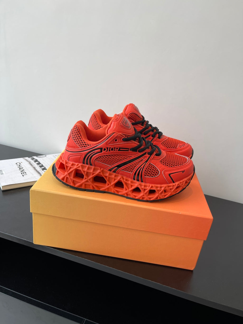 Red Dior ladies sneakers front view with black laces and tread sole