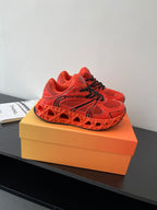 Red Dior ladies sneakers front view with black laces and tread sole