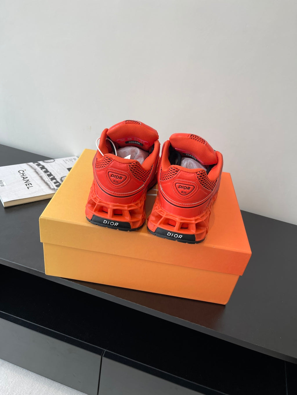 Red Dior ladies sneakers heel view with lace-up closure and logo patch