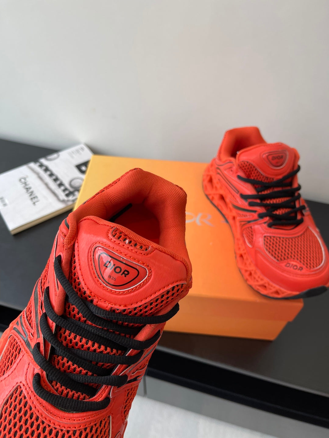 Red Dior sneaker close-up of heel collar and black lace detail