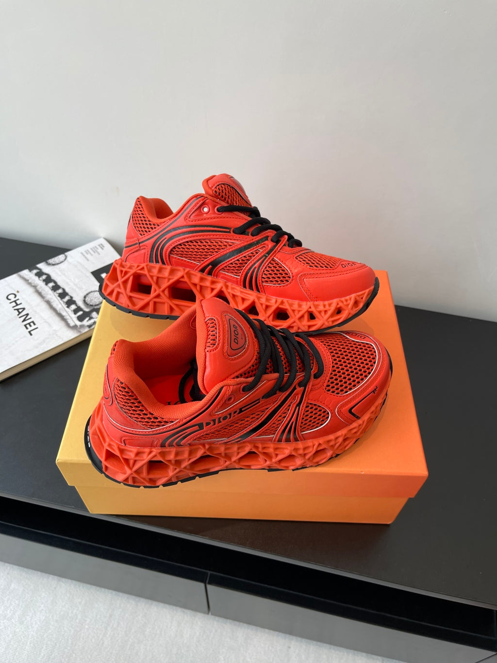 Red Dior ladies sneakers top view with black lace accents and mesh panels