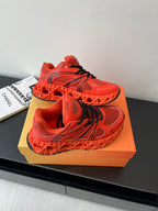 Red Dior ladies sneakers top view with black lace accents and mesh panels