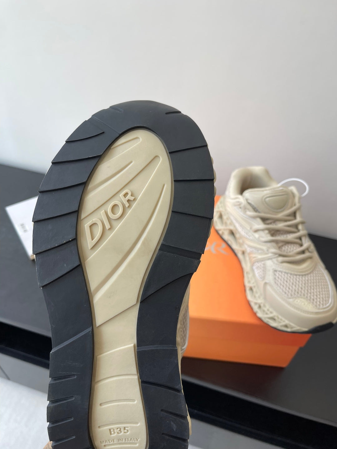 Cream sneaker outsole with DIOR logo on beige tread and stacked rubber segments