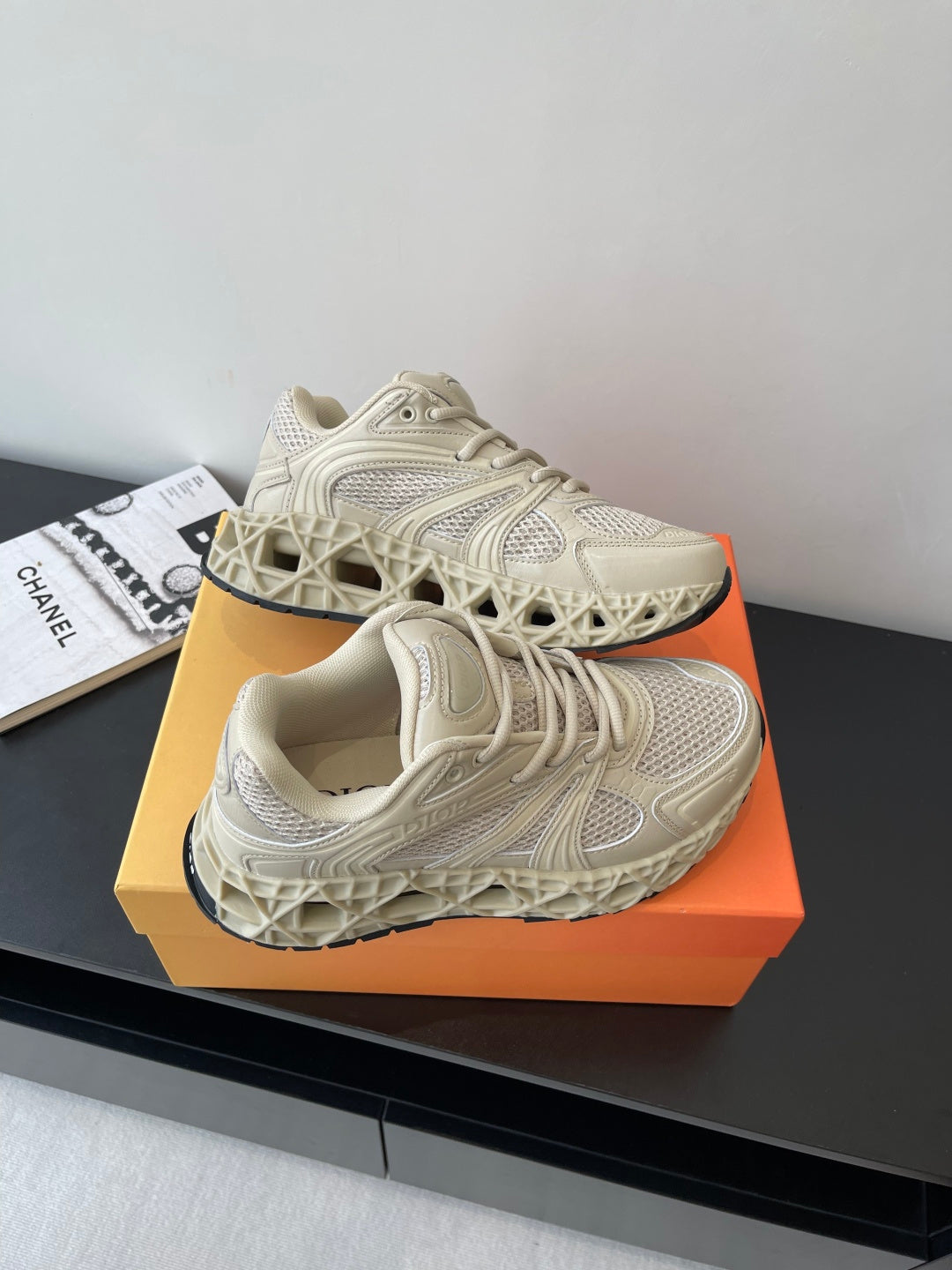 Cream lace-up sneaker with thick tread sole, mesh upper and embossed panel pattern
