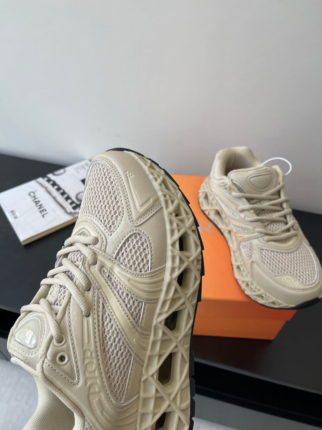 Cream lace-up sneaker with side mesh and embossed details, sneakers on orange box