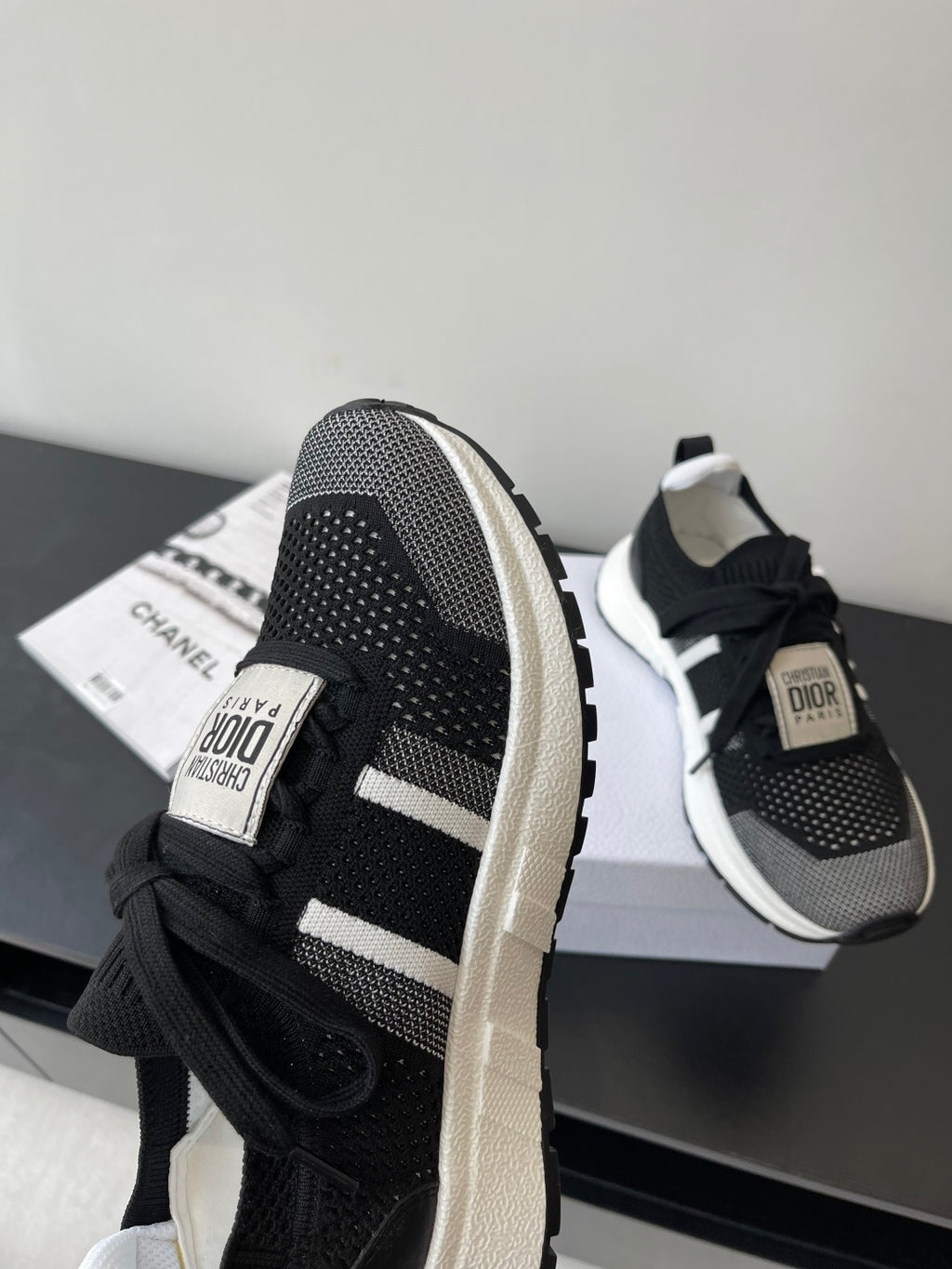 Dior women's black sneakers with white side stripe, lace-up and logo tag