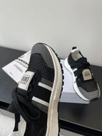 Dior women's black sneakers with white side stripe, lace-up and logo tag