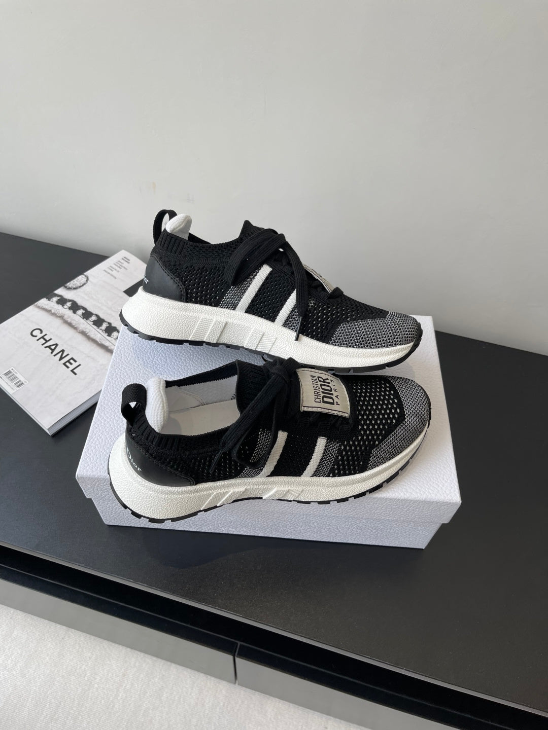 Dior women's black knit sneakers with white sole, lace-up and side strap accents