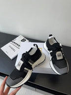 Dior women's black knit sneakers with white midsoles and lace-up details