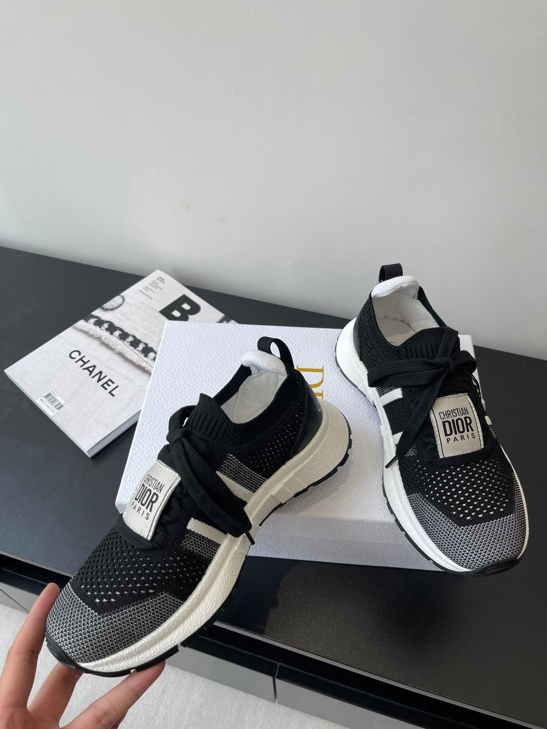 Dior women's black knit sneakers with white midsoles and lace-up details