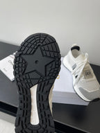 White sneakers with black tread outsole, lace-up design, Dior logo on heel