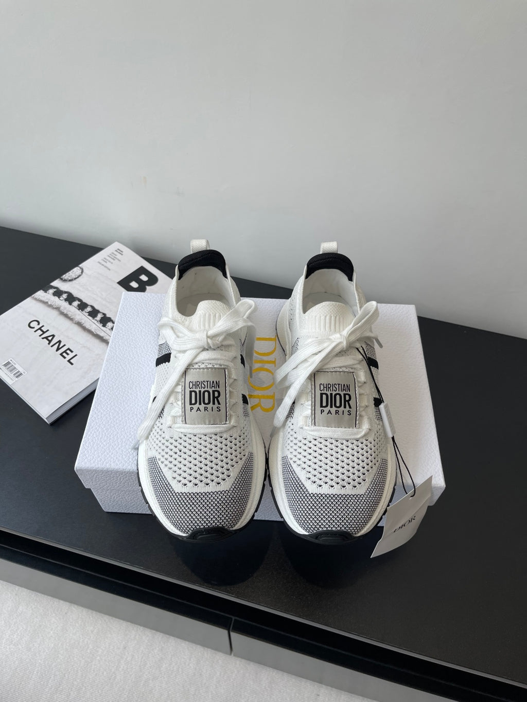 White mesh women's sneaker with black side stripe, white laces, Dior logo heel tag