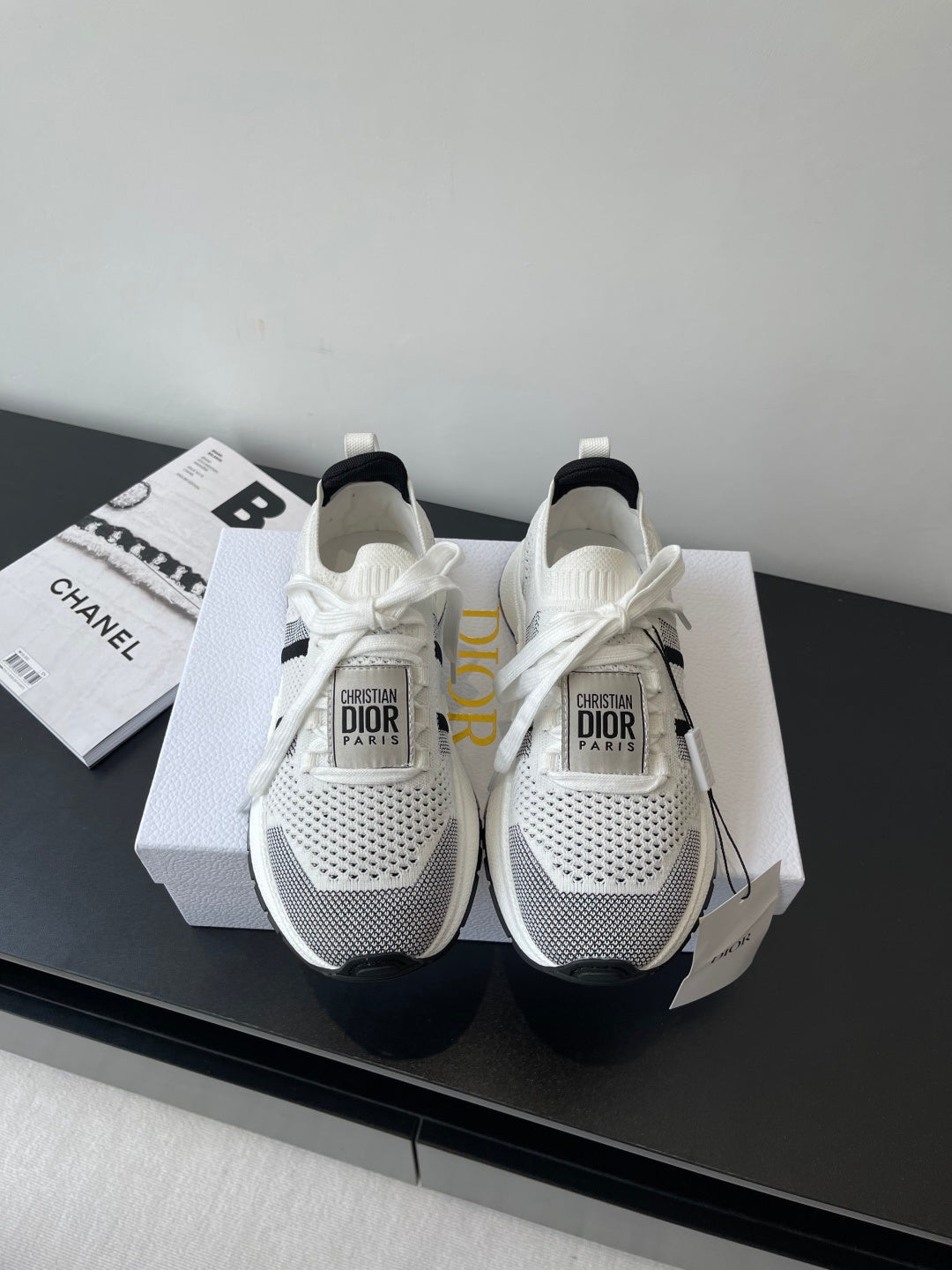 White mesh women's sneaker with black side stripe, white laces, Dior logo heel tag