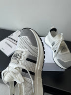 White mesh sneaker with black side stripe, white laces, Dior logo patch on side