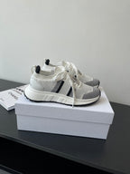 White mesh sneaker with black side stripes and white knit collar, lace-up front