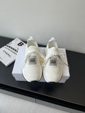 White Dior slip-on sneakers with knit upper, lace ties, and cushioned sole