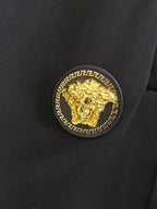 Black shorts fabric with gold medallion logo patch