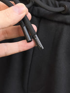 Black drawstring cord with small VERSACE text label