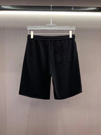 Versace black shorts with gold emblem and front patch pocket