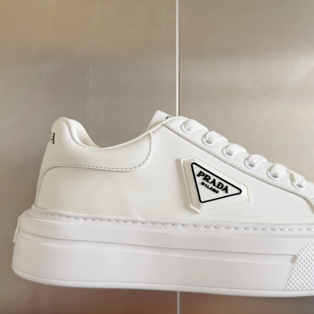 White leather lace-up sneaker with PRADA logo patch and stitched side panels