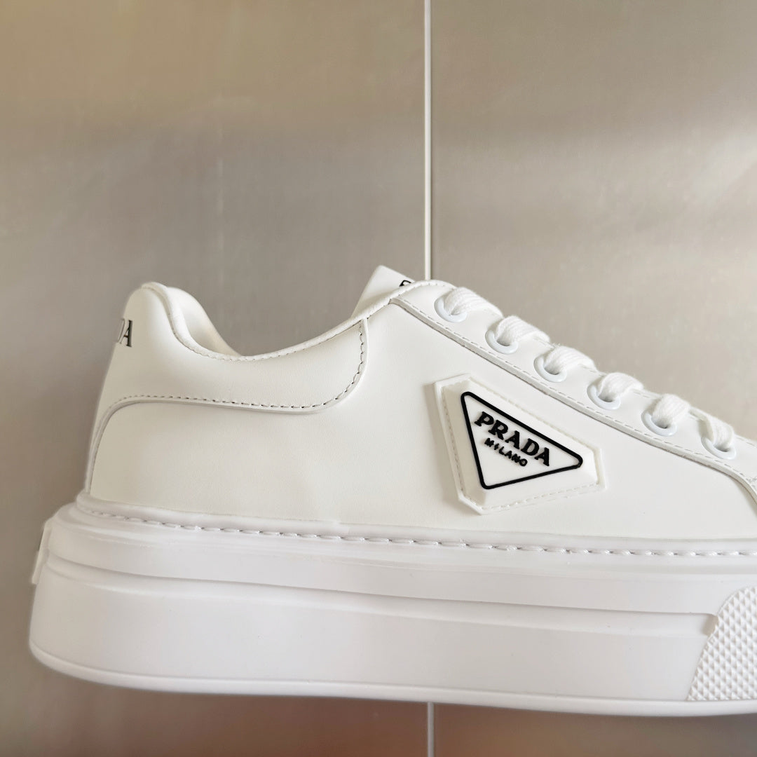 White leather lace-up sneaker with PRADA logo patch and stitched side panels