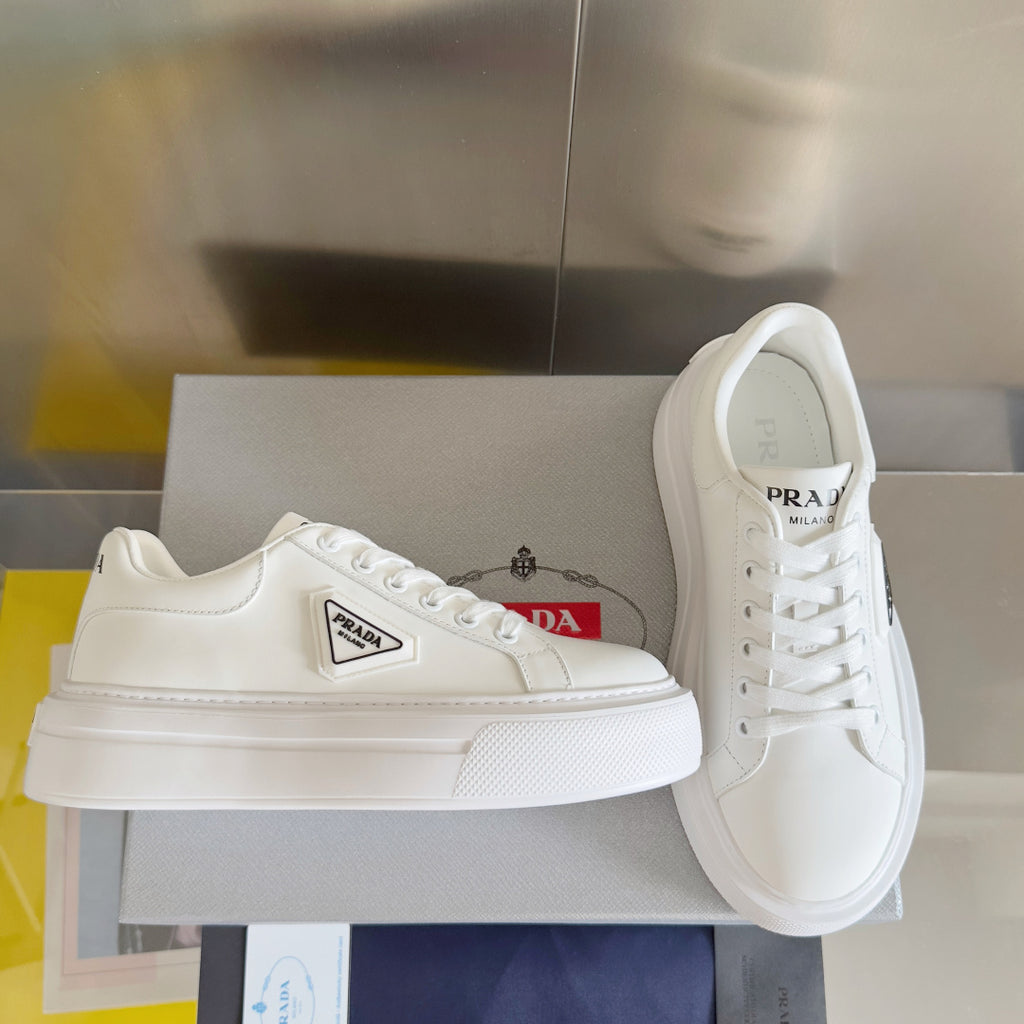 Unisex white leather sneakers with PRADA side logo patch and lace-up front