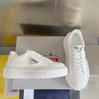 Unisex white leather sneakers with PRADA side logo patch and lace-up front