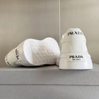 Unisex white sneakers with PRADA logo on heel and textured outsole tread