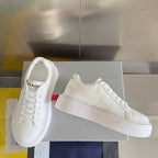 Unisex white leather sneakers on a box with PRADA logo on the heel