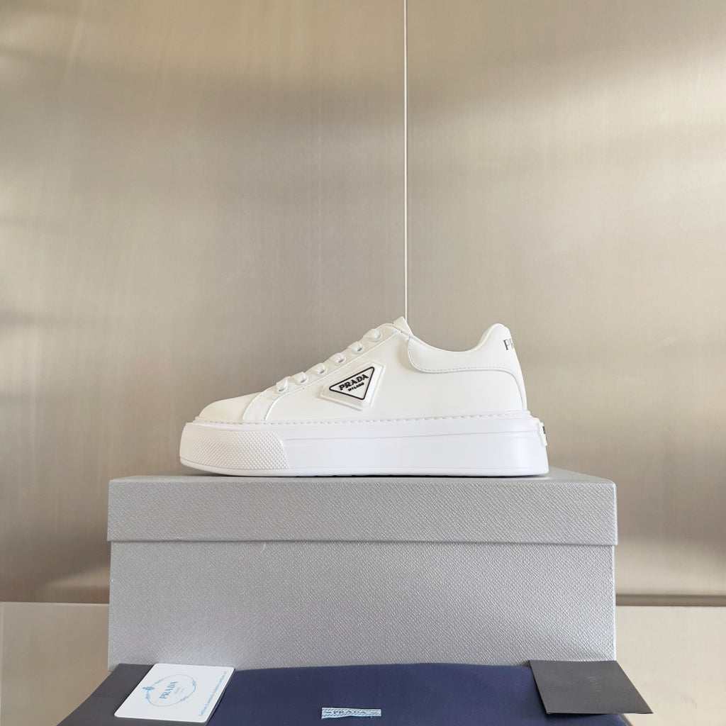 Unisex white leather sneakers with PRADA logo patch and low-profile sole