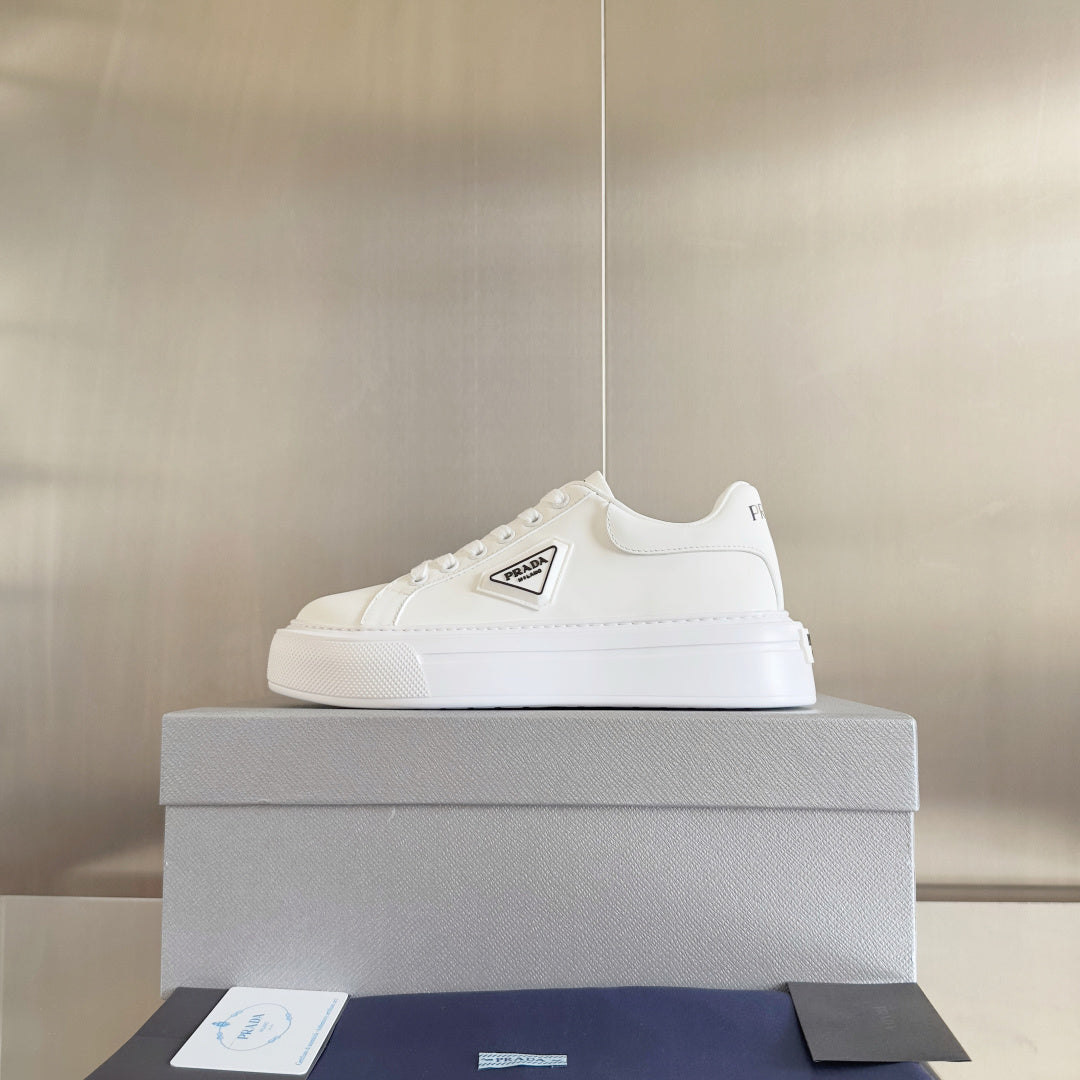 Unisex white leather sneakers with PRADA logo patch and low-profile sole