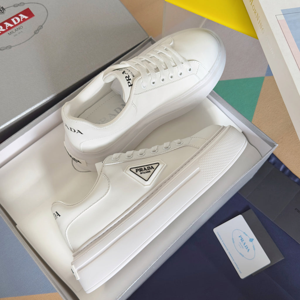 Unisex white leather lace-up sneakers with PRADA logo patch on the side