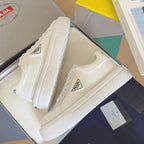 Unisex white leather sneakers with PRADA logo patch and textured rubber sole