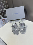 Silver slide sandals with multi-buckle straps and black block heel